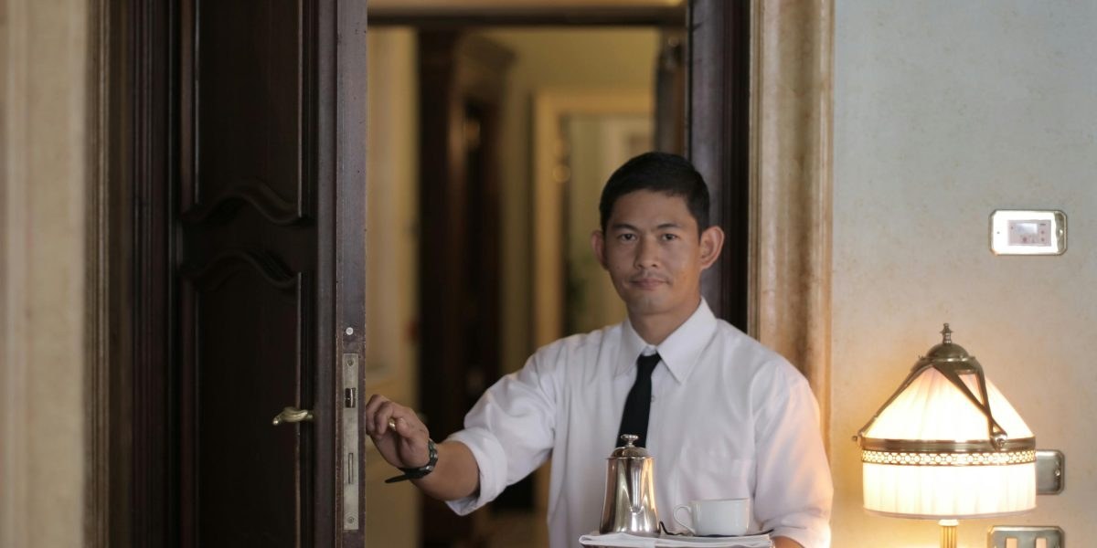 Guest entering a serviced apartment with luggage in Dubai