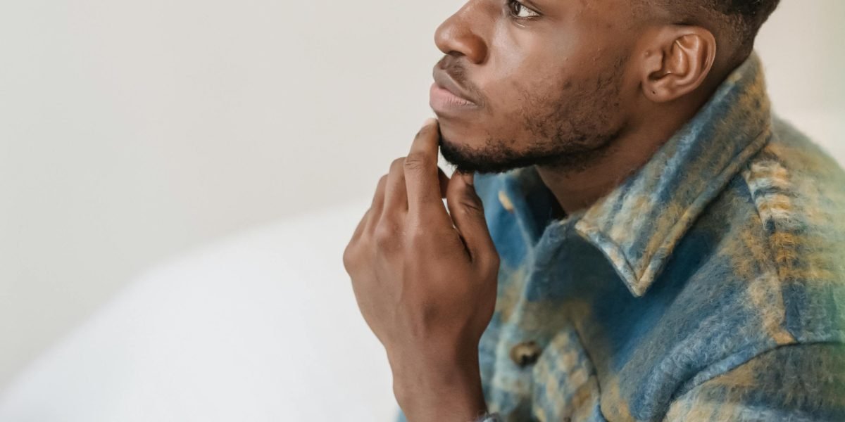 A person sits thoughtfully, reviewing various housing options and preferences.