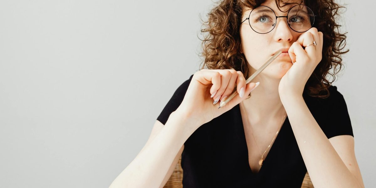 An investor thoughtfully considering various options to make an informed investment decision.