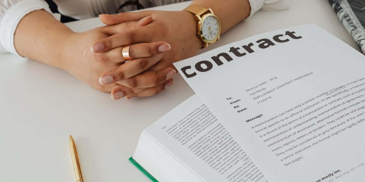 Someone meticulously reviewing a checklist or contract, emphasizing the importance of thorough due diligence before a major decision.