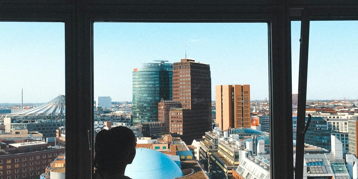 An investor contemplating opportunities while looking out at the dynamic Dubai cityscape.