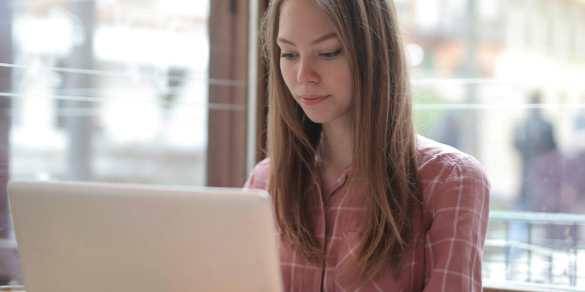 A traveler diligently comparing various hotel booking options and prices on a device to find the best deal.