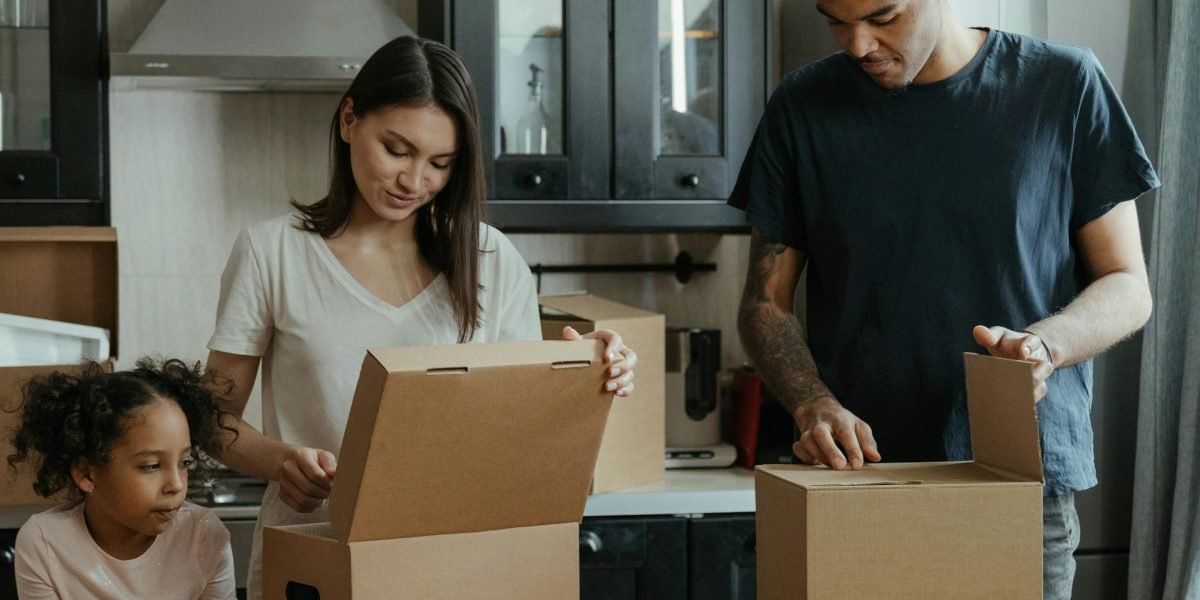 An expat family or couple getting comfortable in a new, modern apartment space.