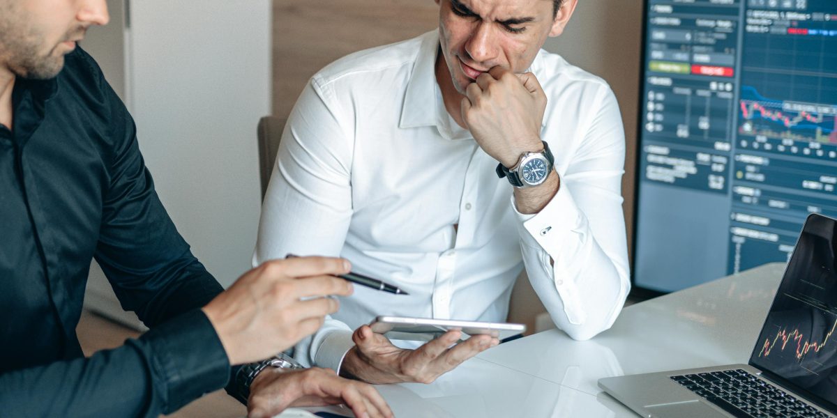 Two people engaged in a discussion about investment prospects in a modern office setting.