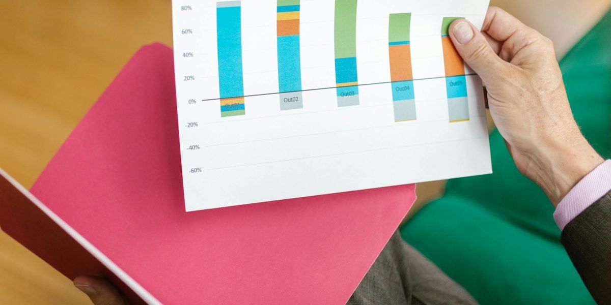 A focused businessperson meticulously reviewing financial documents and projections.