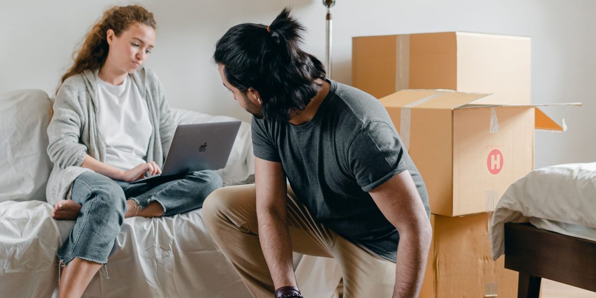 An individual unpacking or arranging items, settling into a new apartment or temporary residence.
