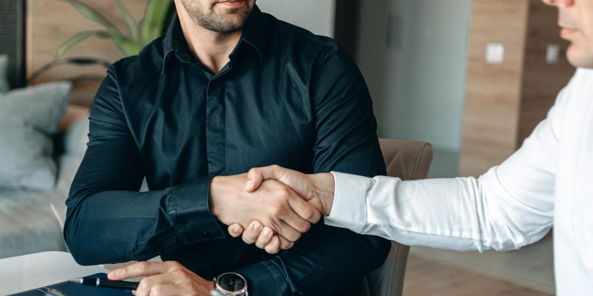 Two professionals shaking hands, indicating a successful business agreement or partnership.