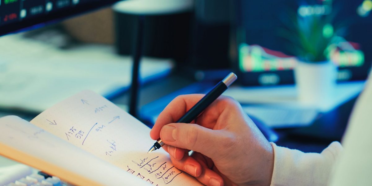 A professional reviewing financial documents or an investment plan at a desk, indicating careful consideration of property investment.