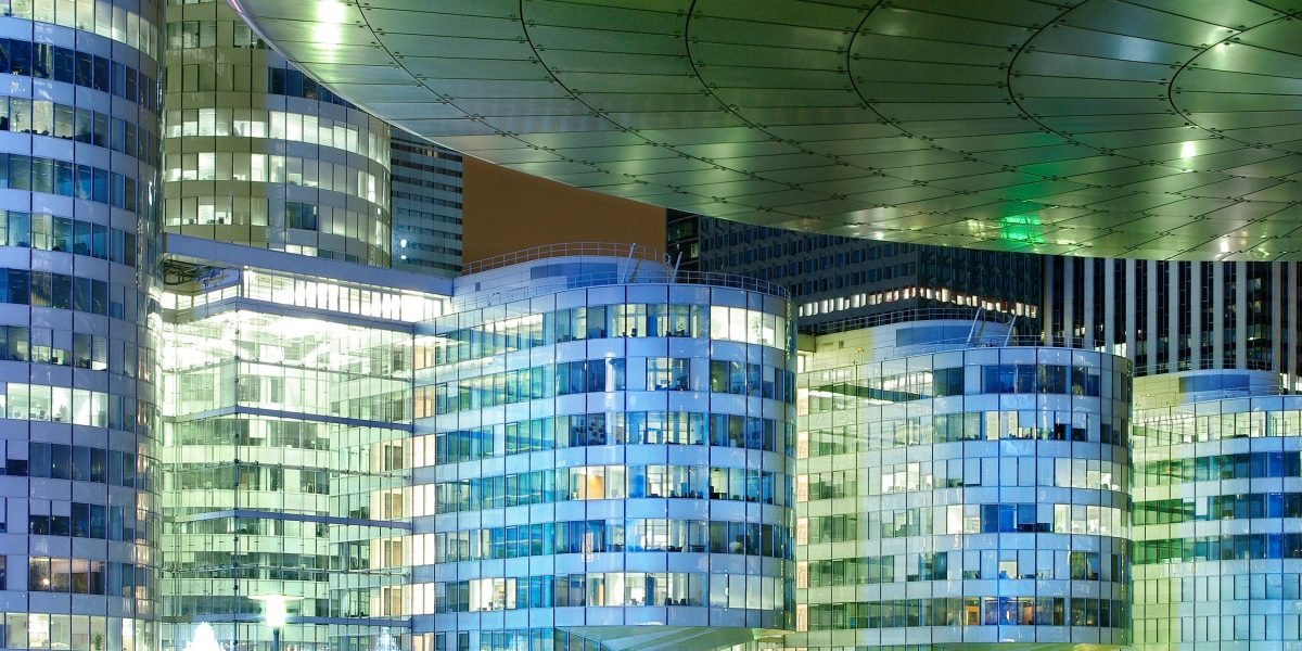 People contemplating a futuristic city skyline, representing forward-thinking discussions about investment and growth in luxury hospitality.