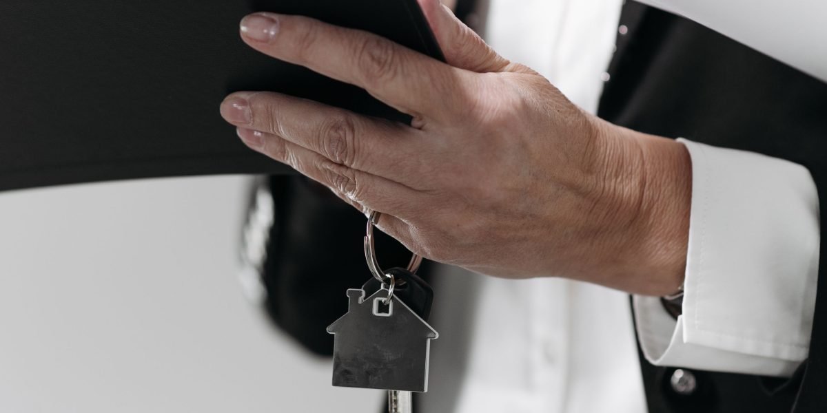 An individual analyzing financial documents, representing the decision-making process for investing in property.