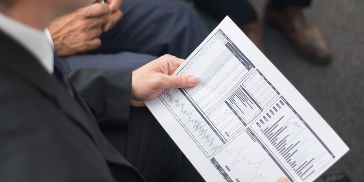 A professional reviewing financial documents, representing careful investment planning.