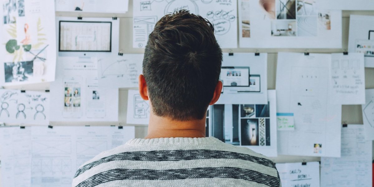 A person thoughtfully considering travel options, navigating through abundant information to make a decision.