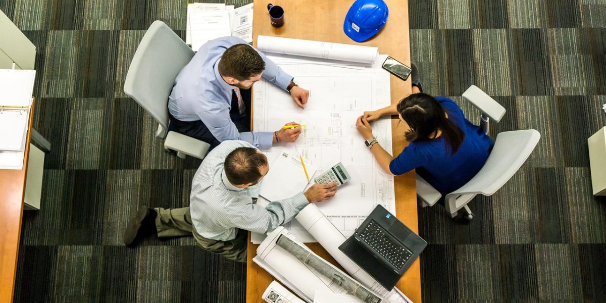 Professionals engaged in a discussion about real estate investment opportunities and market potential.