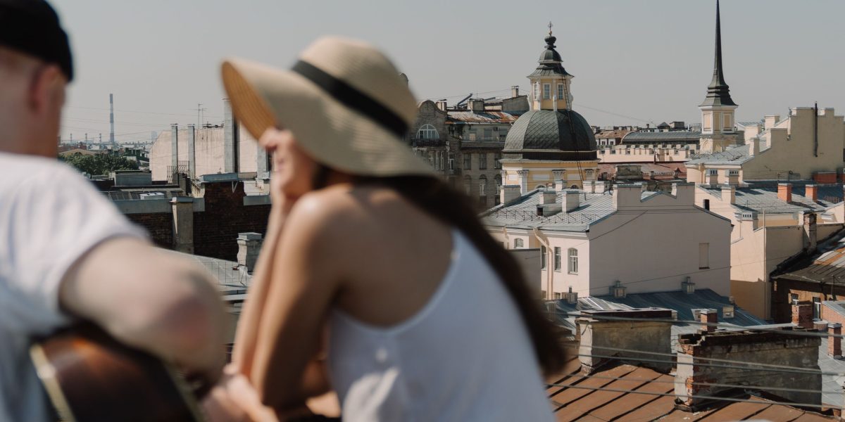 A couple enjoying the panoramic view from a high-end apartment, reflecting a premium stay experience.