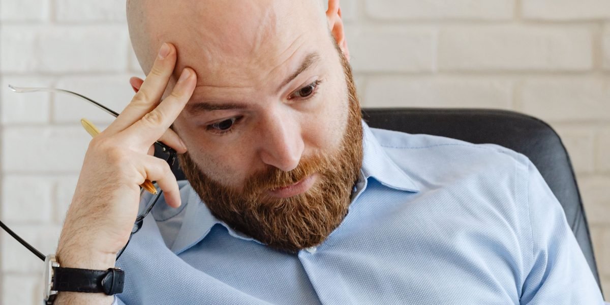 A person considering various options for accommodation, reflecting the challenge of choice.