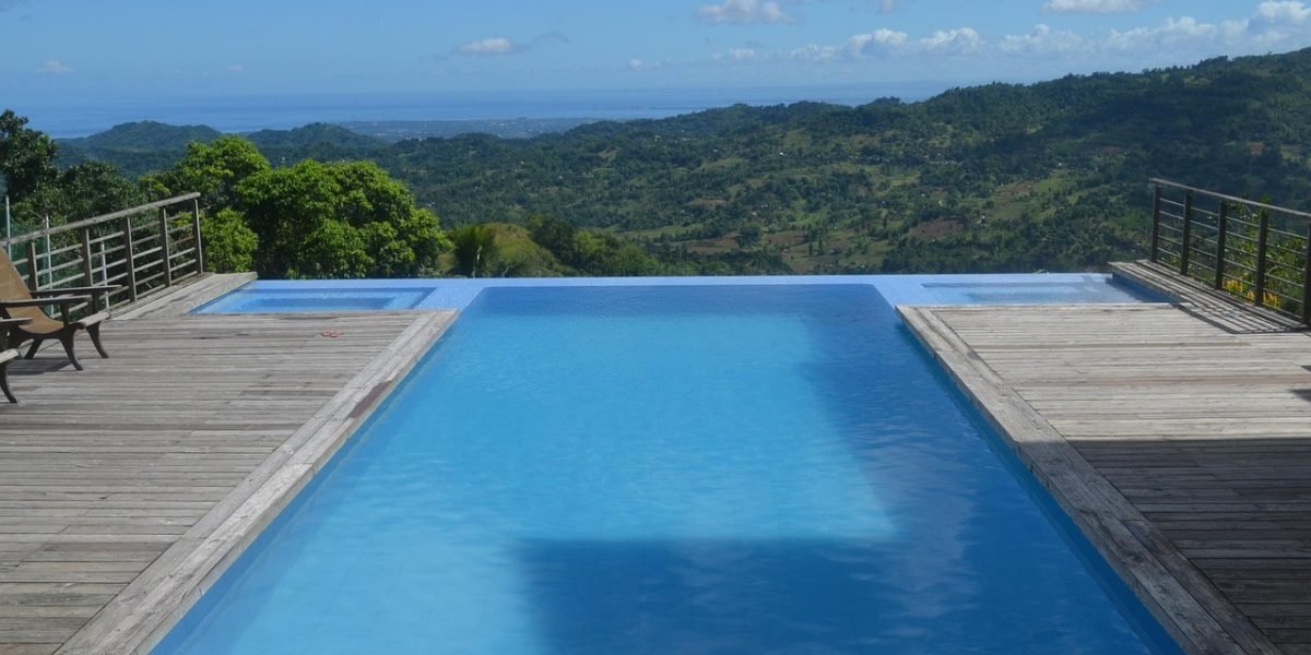 Guests enjoy a serene moment by the pool at a luxurious resort, reflecting relaxation and comfort.