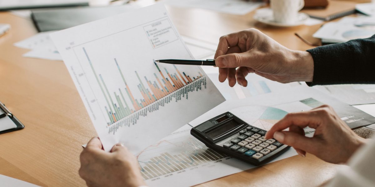 Professionals analyze financial data, discussing potential returns and investment strategies in the real estate market.