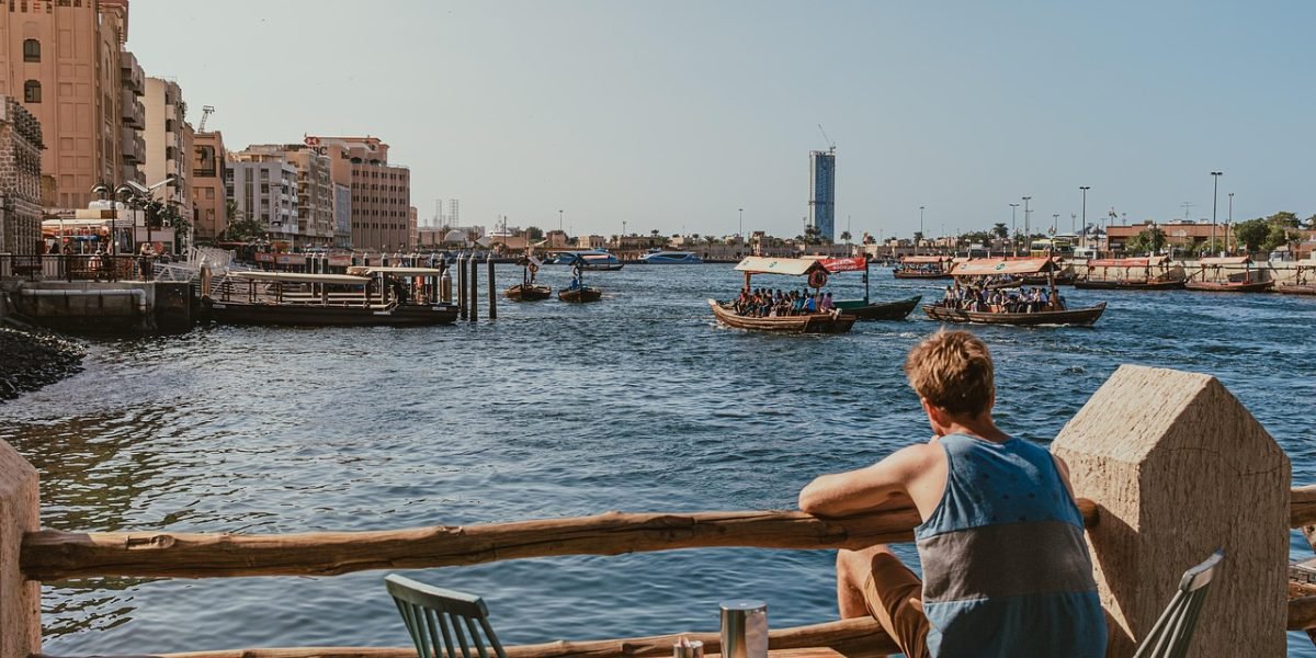 People enjoying a traditional abra boat ride across the Dubai Creek, showcasing one of Deira's iconic experiences.