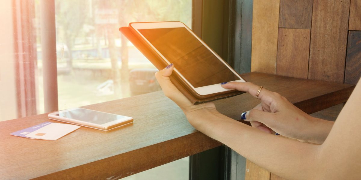 A person comparing hotel prices on a tablet, illustrating the process of finding the best deals for a stay.