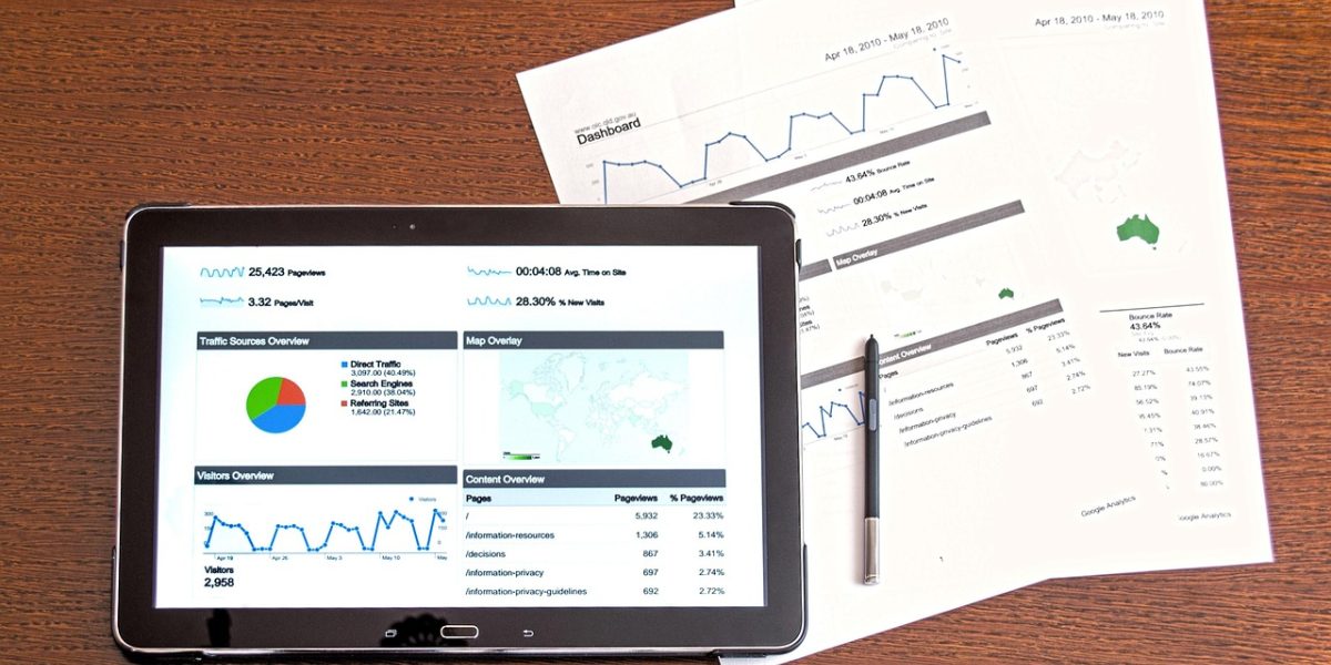 A team of professionals collaborating, analyzing charts and reports related to real estate investment.