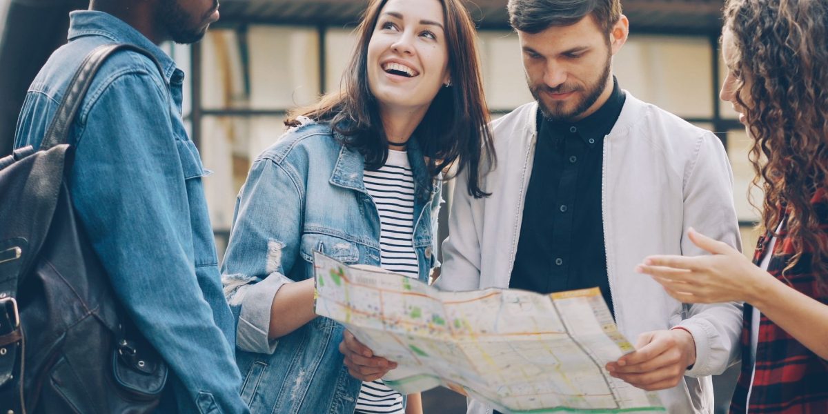A vibrant scene depicting a diverse group of tourists, including families and couples, exploring the attractions of Dubai.