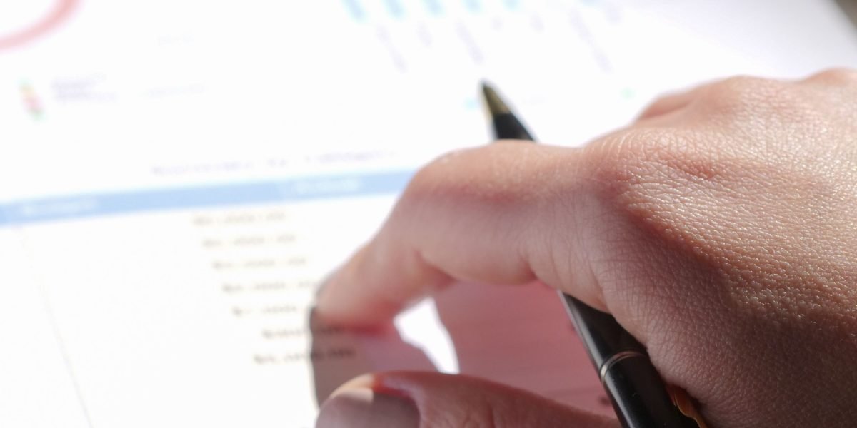 A professional reviewing financial documents and market reports, symbolizing the investment perspective on hotel apartments.