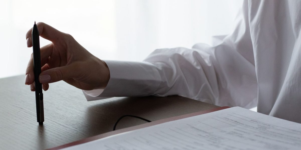 An individual thoughtfully reviewing documents, emphasizing the importance of informed decision-making for property investment.