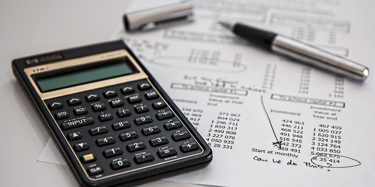 Professionals review documents, considering real estate investment opportunities in a modern office setting.